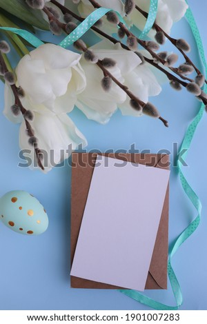 Easter greeting card. willow twigs, spring flowers and Easter eggs. space for congratulation text. flat lay