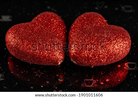 Romantic love red heart on the black background. Valentine's day concept. Horizontal close-up macro shot. High quality image.