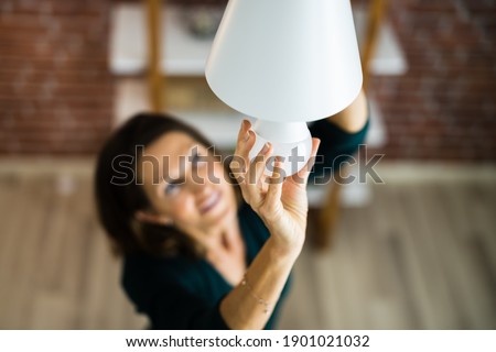 Electric LED Lightbulb Change In Light At Home Royalty-Free Stock Photo #1901021032