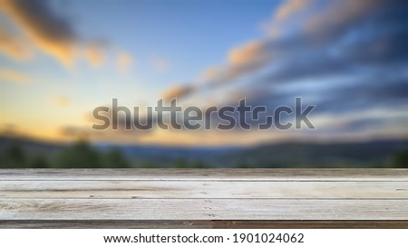 Empty wood table and  green mountain background. blurry view. suitable for your product display