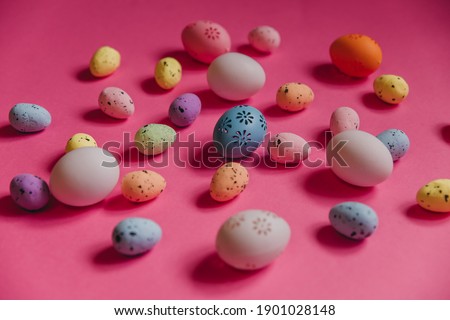 Colored bright easter eggs on a pink background. Blue, yellow, pink eggs. Festive background. Easter game for kids. Collect eggs.
