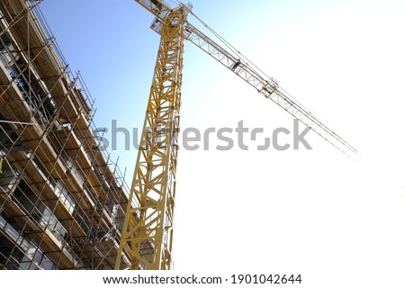 under construction building with tower crane 