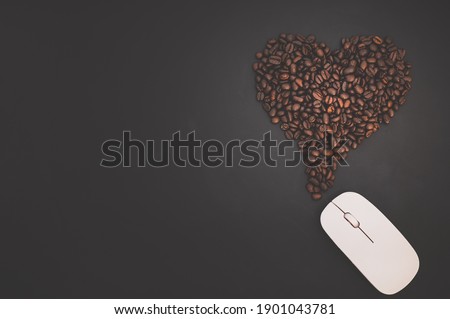 Coffee love concept The computer mouse and coffee beans form heart shapes that represent energy of work.