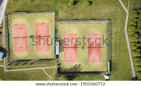 Park with tennis courts above drone top view on bright sunny day