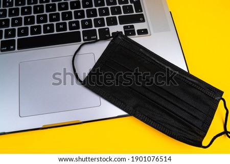 mask on yellow background computer