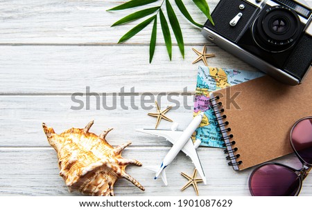 Flat lay traveler accessories on wooden background with blank space for text. Top view travel or vacation concept. Summer background.