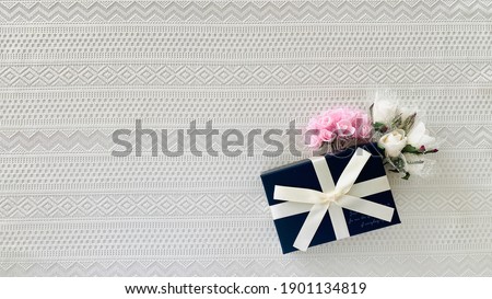 Navy blue present box and flowers_bottom left of lace background