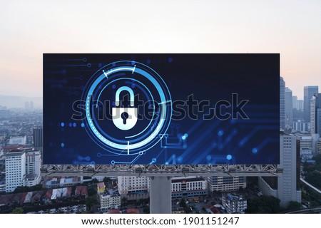 Padlock icon hologram on road billboard over panorama city view of Kuala Lumpur at sunset to protect business, Malaysia, Asia. The concept of information security shields.