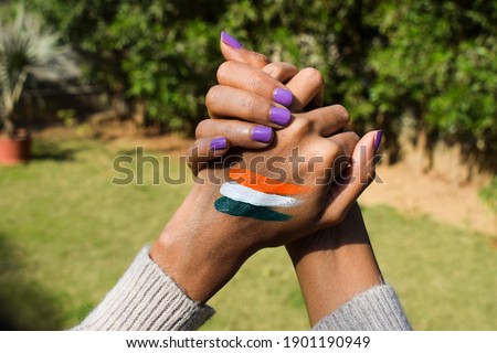 Indian flag tattoo of tri colour painted on person's hand cheering and celebrating Indian republic day Royalty-Free Stock Photo #1901190949