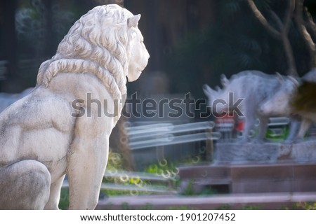 Old lion statue in garden