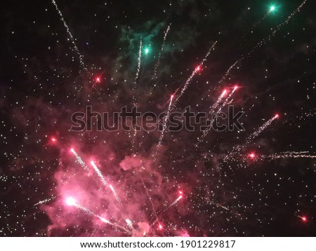 Multicolored new year fireworks in the dark sky