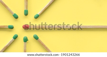 Persuasion, influence, sharing ideas and social network concept. Red matchstick surrounded by green ones, copy space, flat lay, top view. Royalty-Free Stock Photo #1901243266