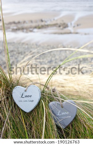 two blue wooden love heart in dunes on an Irish beach