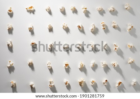 Sweet or salty piece popcorn on gray background. Concept of different pieces popcorn.