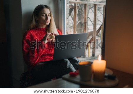 Woman using online dating app on laptop. Valentines Day During The Coronavirus Outbreak. Love at distance, loneliness in self-isolation in the time of coronavirus. Royalty-Free Stock Photo #1901296078