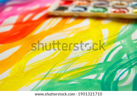 Background from colored undulated lines, pattern made from watercolor paints, top view