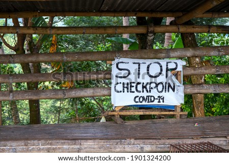 Stop Checkpoint Covid-19 rustic sign banner on wooden stand. South Asia anti covid measures. Travel ban in Philippines. Stop banner template. Covid checkpoint in rustic village. Virus pandemic action 