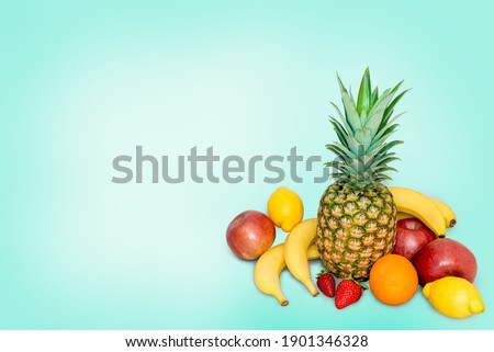 A pile of fresh fruits on a blue background.