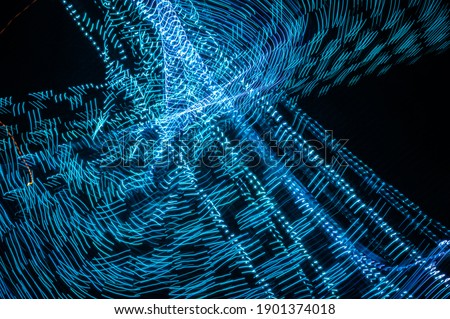 Light painting abstract background. Blue light painting photography, long exposure, ripples and swirl against a black background.