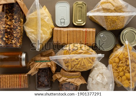 Home food supplies, necessary food for the period of quarantine and isolation, the concept of stay at home, canned food , various pasta and flour, sugar and cookies, top view