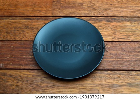 An empty plate on wooden table