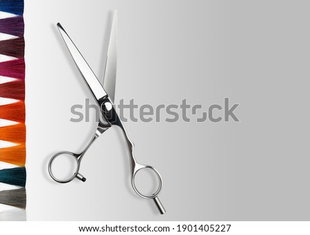 Scissors and colored Hair. Professional barber hair cutting scissors. Hairdresser salon equipment concept, premium hairdressing shears. Accessories for haircut. Price list or business card background

