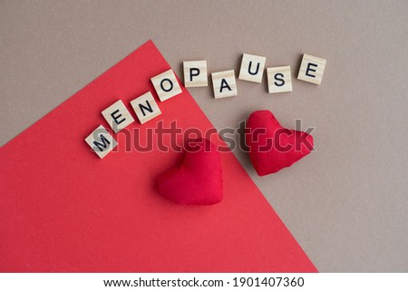 Concept. The inscription from the letters menopause. Symptoms of Menopause Harmonious changes in women older than 40 years. Royalty-Free Stock Photo #1901407360