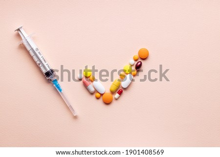 medical pills check mark symbol isolated on pink background. medicine approve sign concept. outer space. above view.