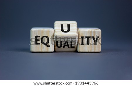 Equality or equity symbol. Turned a cube and changed the word 'equality' to 'equity'. Beautiful grey background. Psychology, business and equality or equity concept. Copy space. Royalty-Free Stock Photo #1901443966