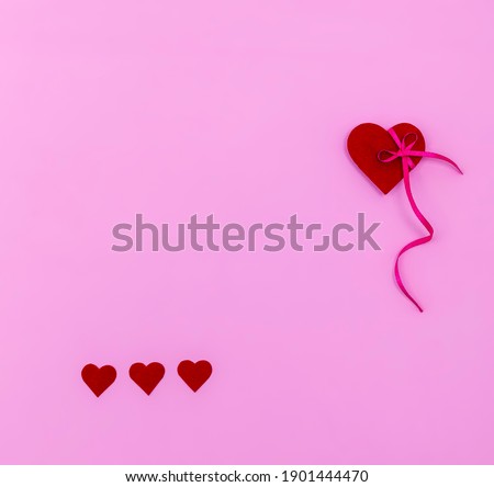 Red hearts background, paper cut romantic concept, top view. Beautiful cute hearts on pastel pink table flat lay composition. Valentines Day greeting card concept. Mothers Day anniversary design.