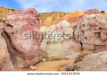 the colorful, eroded pink and yellow hoodoos on a sunny winter day in the paint mines interpretive park near calhan, colorado