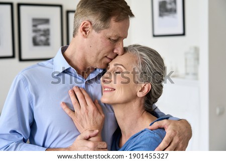 Happy older senior mature affectionate couple hugging, bonding together. Retired grandparents cuddling, enjoying sweet tender warm moment of love and wellbeing, feeling support concept, closeup. Royalty-Free Stock Photo #1901455327