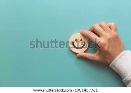 Customer putting wood sphere smile face emoticon for rating. Service rating, feedback, satisfaction concept Royalty-Free Stock Photo #1901459761