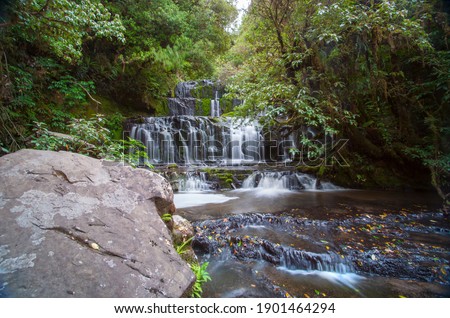Scenic Purakaunui Falls cascade  down three rock terraces in middle of bush  in Catlins South Island New Zealand.