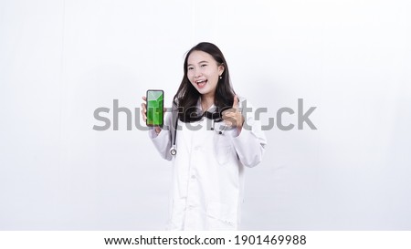 asian woman doctor holding green screen phone isolated white background