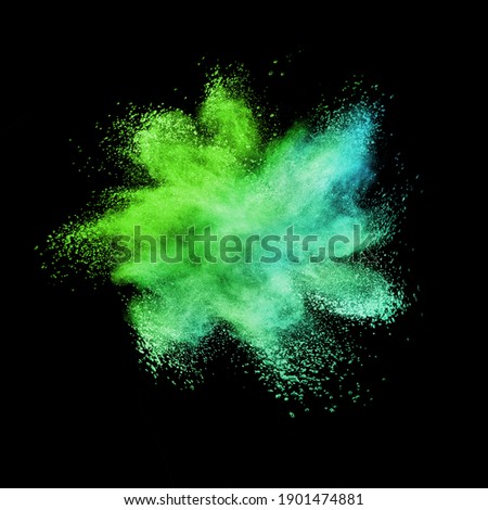 Decorative chaotic multicolored powder burst or explosion on a black background with copy space. Royalty-Free Stock Photo #1901474881