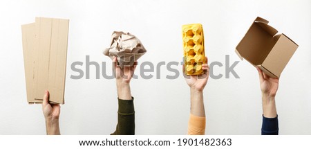 Separate collection of paper garbage. Human hands holding paper stuff for recycle. Eco friendly people. Man's hand holds recyclable paper waste on white: cardboard, craft paper, egg carton and postbox Royalty-Free Stock Photo #1901482363
