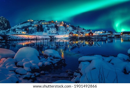Scenic photo of winter fishing village with northern lights. stunning natural background. Picturesque Scenery of Reinefjord one most popular place of Lofoten islands. Norway. ideal resting place. Royalty-Free Stock Photo #1901492866