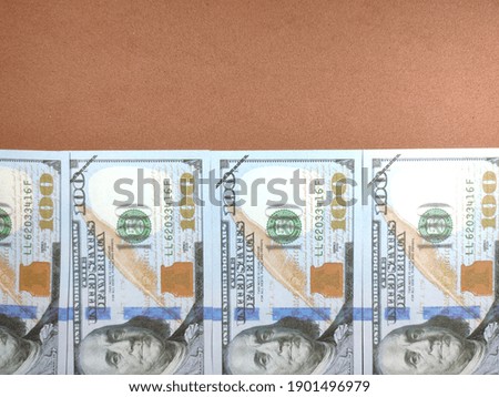 Selective focus.Fake dollar money on a brown background.Shot were noise and film grain.