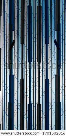 Colorized double exposure photo of structural glazing. Abstract modern architecture. Windows of  hi-tech building. Geometric background. Polygonal pattern of reflective panels with parallel lines.