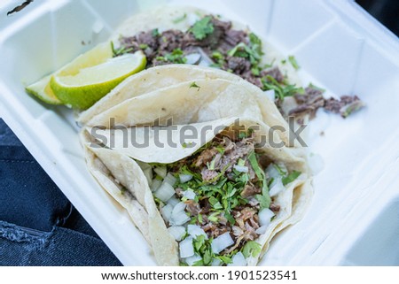 Carnitas and lengua tacos on a plate