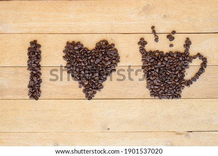Top view of coffee bean sort to Love coffee word on wood plate