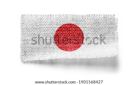 Japan flag on a piece of cloth on a white background