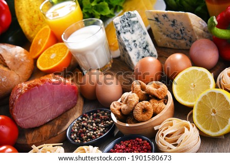 Assorted organic food products on wooden kitchen table.