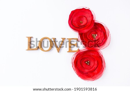 Love and romance concept background, valentine card background idea, wooden love font with red fabric flower isolate on white background