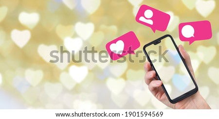 Hand with phone and social media icons on romantic background