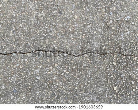 Great background for cracking texture of rough asphalt, it can be used as cracked concrete wall. The surface covered with gray cement and this is a great resource for grunge wallpaper