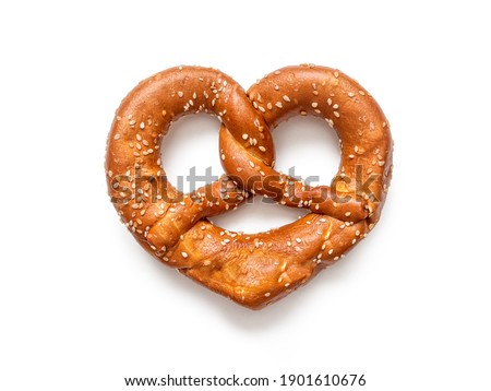 Brezel - a pretzel sprinkled with sesame seeds, in the form of "crossed arms", widely distributed in southern Germany, isolated on a white background Royalty-Free Stock Photo #1901610676