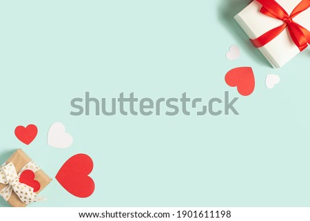 Background with gift and hearts with free space for text on pastel blue background. Valentines day concept. Mother's Day concept. Greetings. Copy space. Flat lay, top view.
