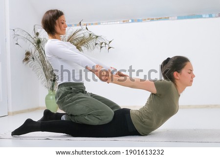Teenager getting Shiatsu massage from Shiatsu masseuse Royalty-Free Stock Photo #1901613232